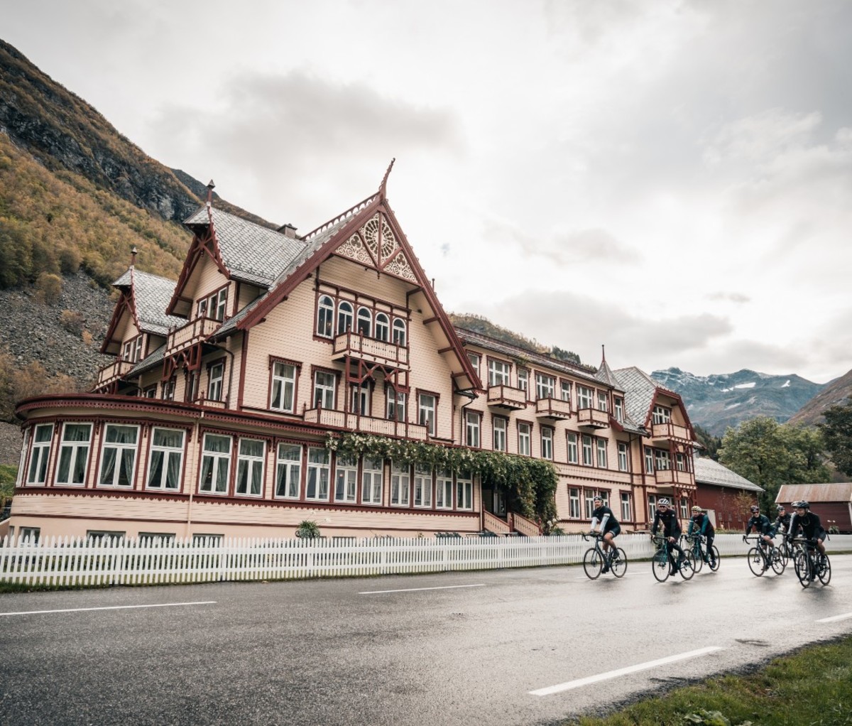 Cyclists riding outside of historic Nordic hotel