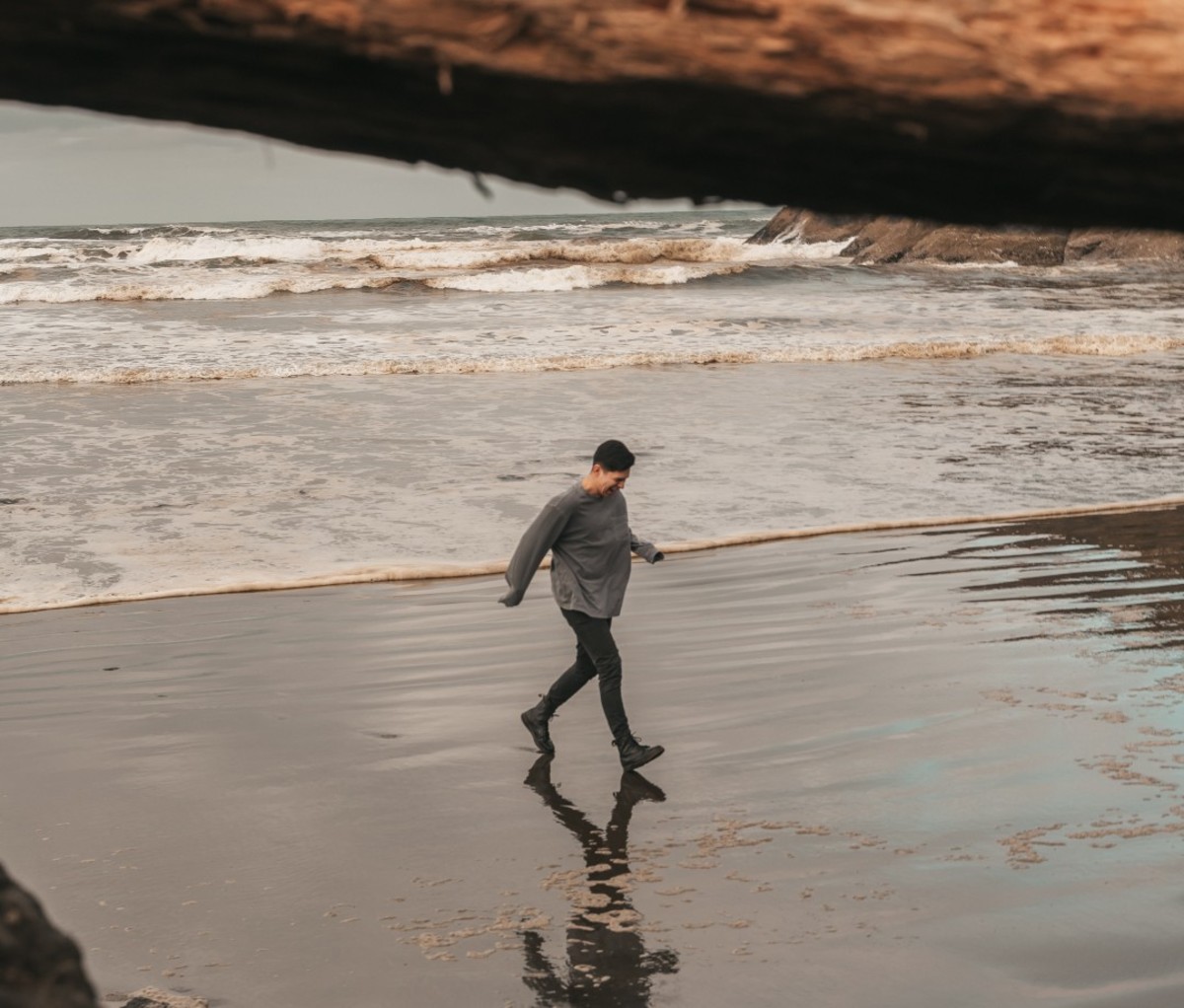 Man walking on beach during winter