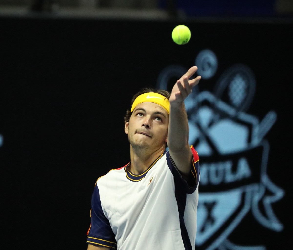 Taylor Fritz serves during a match.