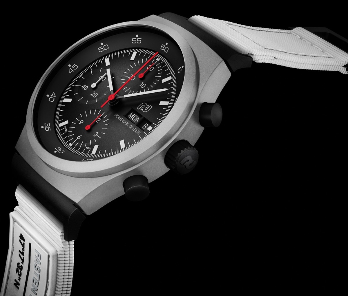 Gray chronograph watch with black dial and white strap on a black background.