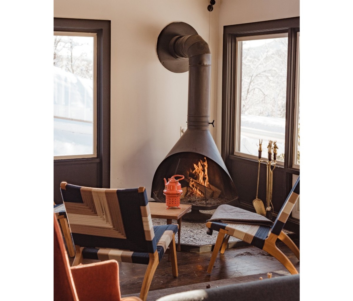 Airy space with chairs positioned in front of fireplace