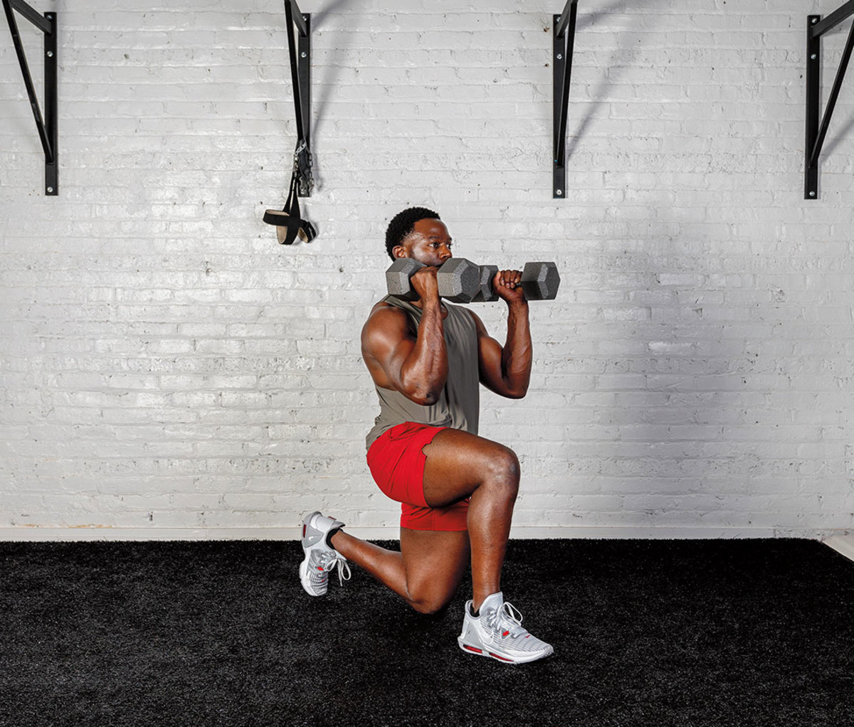 Black man wearing gray tank and red shorts doing Half-kneeling Unilateral Hammer Curl