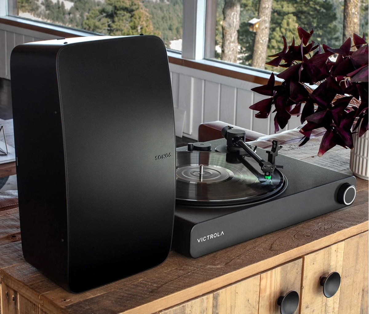 Turntable next to large black Sonos speaker