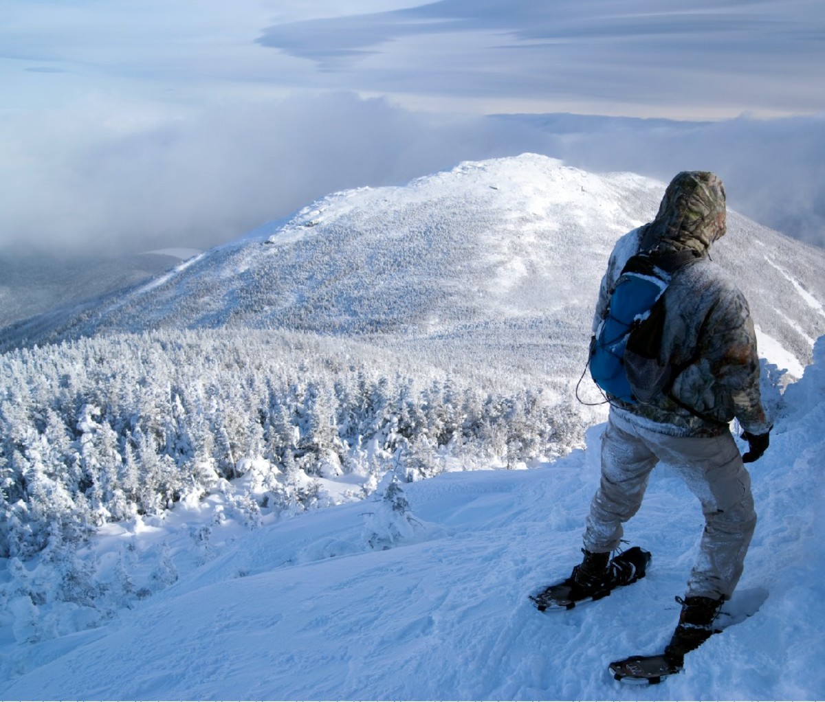 Hiker on a snowy vista in the Adirondacks.