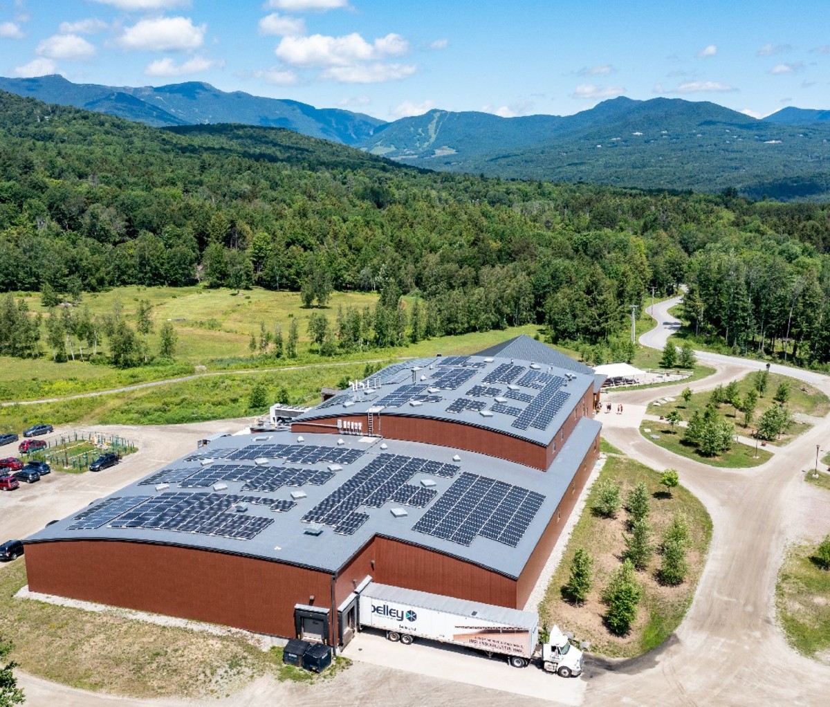 Von Trapp Brewery building with Vermont's Green Mountains in the background.