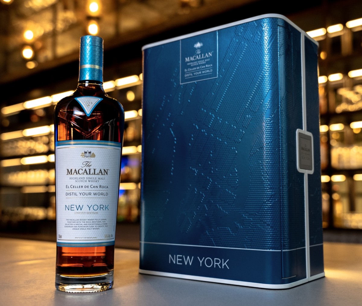 Bottle of The Macallan Distil Your World on bar with blue travel box